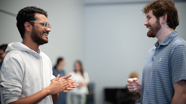 Two Marvell new graduates cheerfully engage in conversation
